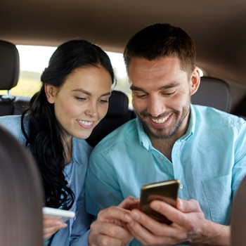 Couple in a Car Using a Phone