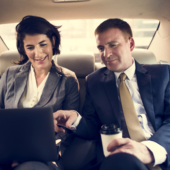 Business Couple Riding In a Car